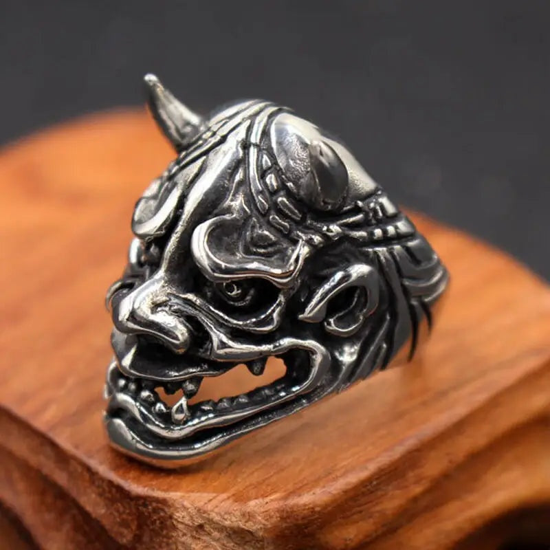 Silver Oni demon ring with horns, displayed on wooden stand | Chaps London