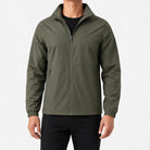 Man wearing olive green zip-up jacket with black pants, front view | Chaps London