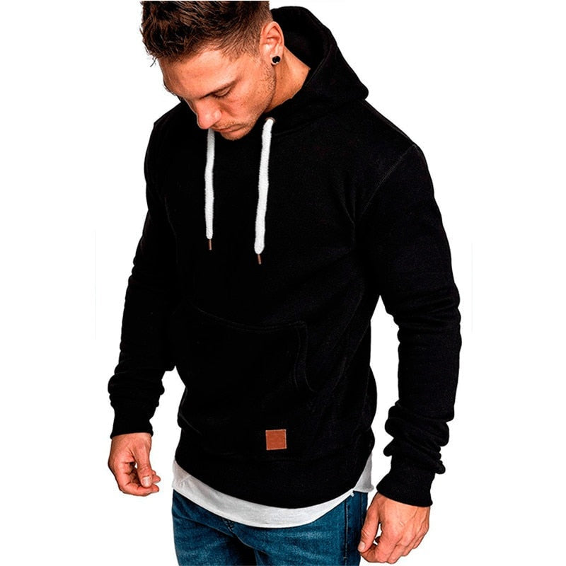 Black hoodie with drawstrings and patch, worn by man, layered hem | Chaps London