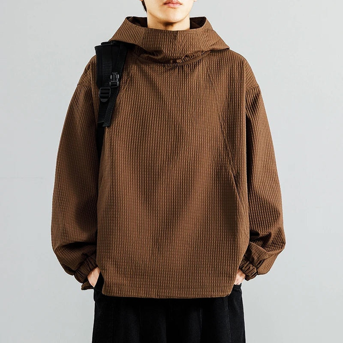 Brown waffle-textured oversized hoodie with funnel neck, worn by man with backpack | Chaps London