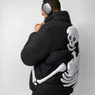 Man wearing black puffer jacket with white skeleton arm graphic on back | Chaps London