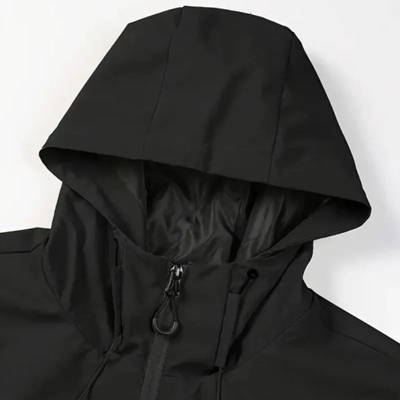 Black hooded rain jacket close-up showing zipper and drawstring details, worn by person | Chaps London