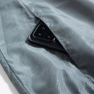 Gray windbreaker interior pocket with smartphone, subtle patterned lining fabric visible | Chaps London