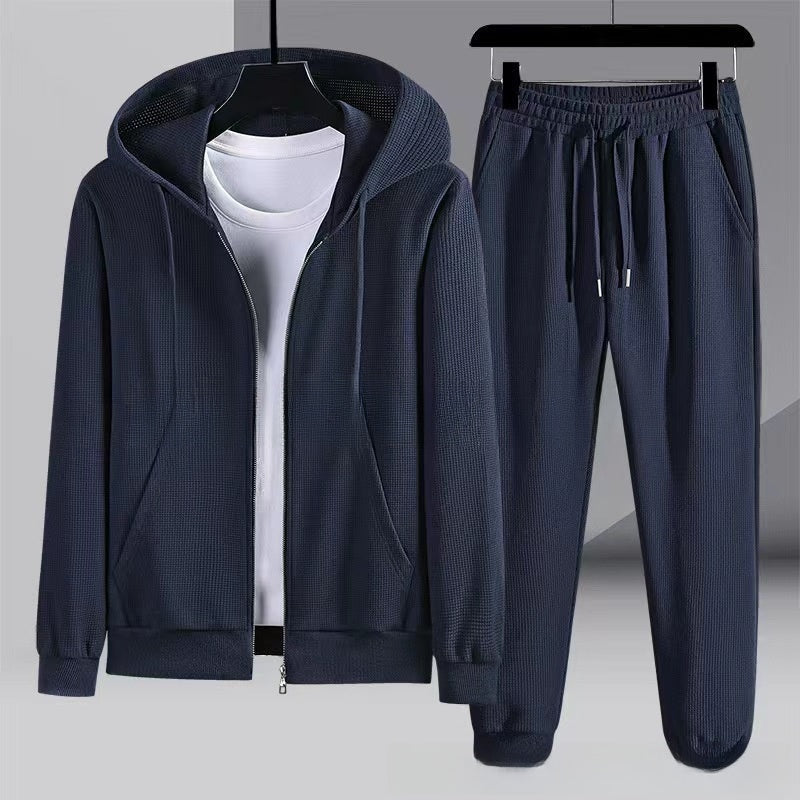 Navy blue waffle-textured zip hoodie and jogger pants on hangers | Chaps London