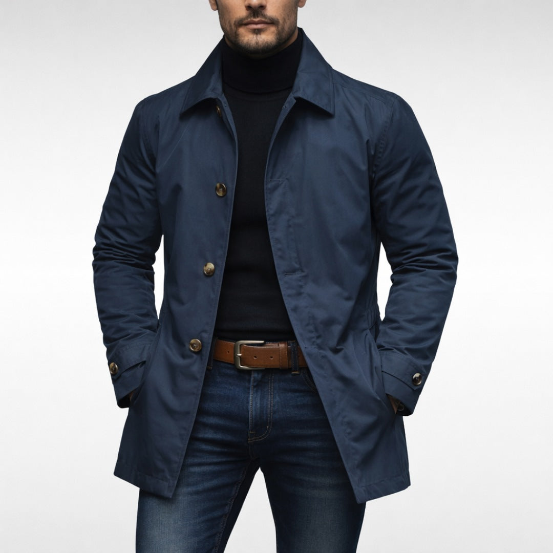 Man wearing navy blue button-front trench coat with black turtleneck and jeans | Chaps London