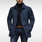 Man wearing navy blue button-front trench coat with black turtleneck and jeans | Chaps London