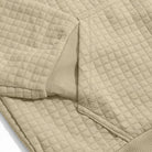 Beige quilted hoodie fabric close-up showing ribbed cuff and texture detail | Chaps London