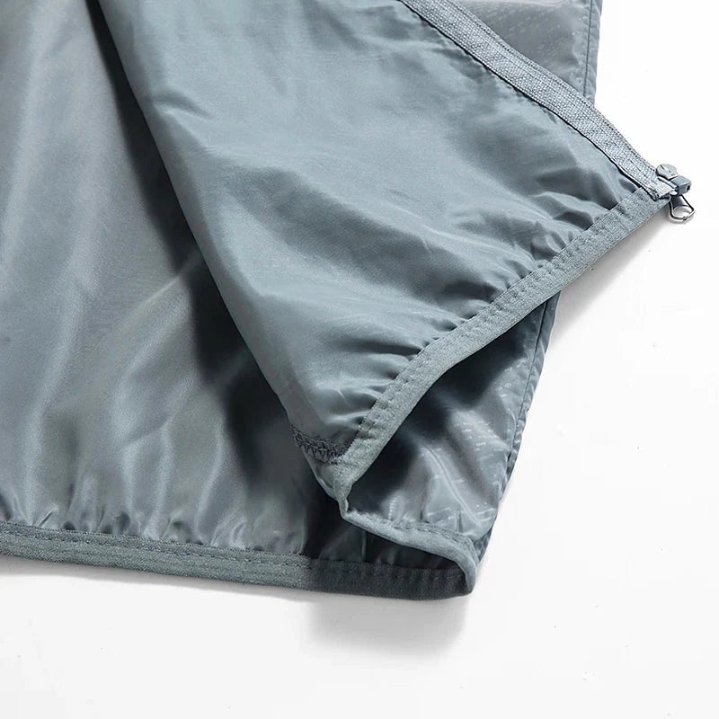 Grey nylon windbreaker fabric close-up showing zipper and stitched hem detail | Chaps London