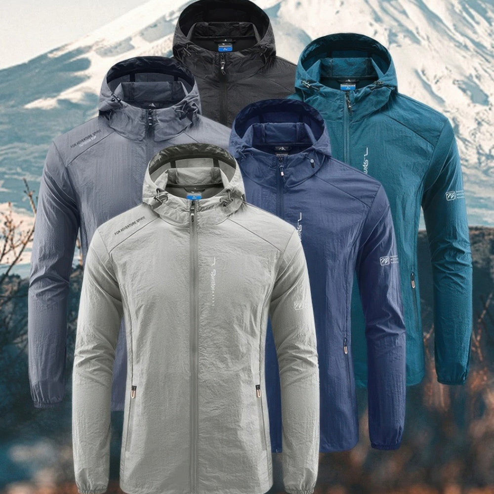 Hooded lightweight jackets in six colors, flat-laid against mountain background | Chaps London