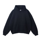 Black oversized hoodie with kangaroo pocket, laid flat, front view | Chaps London