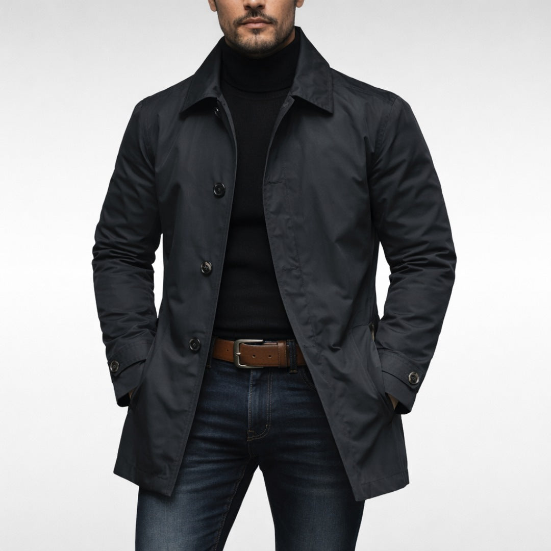 Man wearing black button-front trench coat over turtleneck and jeans | Chaps London
