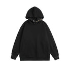 Black oversized hoodie with snap neck closure, shown flat, front view | Chaps London
