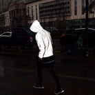 Man wearing reflective white hooded jacket with black pants on street | Chaps London