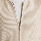 Cream ribbed knit zip cardigan close-up with silver zipper, worn by person | Chaps London