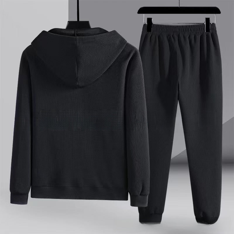 Black waffle-textured zip hoodie and matching joggers on hangers | Chaps London