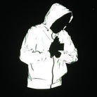 Reflective silver hooded jacket worn by person, glowing against black background | Chaps London