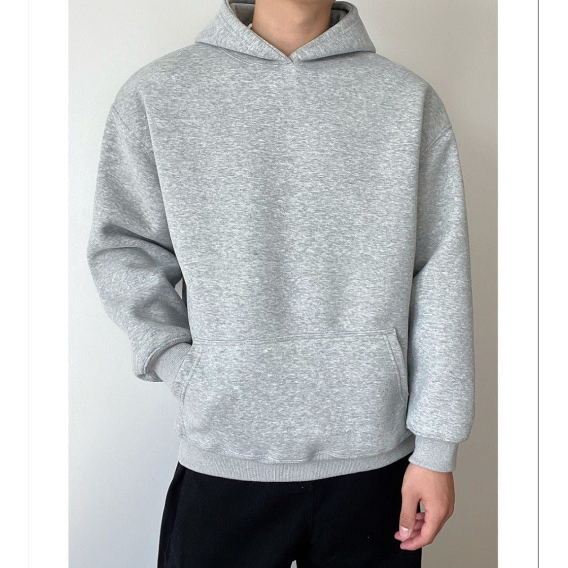 Man wearing plain grey oversized hoodie with kangaroo pocket, front view | Chaps London