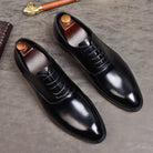 Black Oxford dress shoes with laces, shown flat with shoe trees inserted | Chaps London