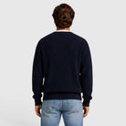 Man wearing navy ribbed knit sweater, back view, with light blue jeans | Chaps London