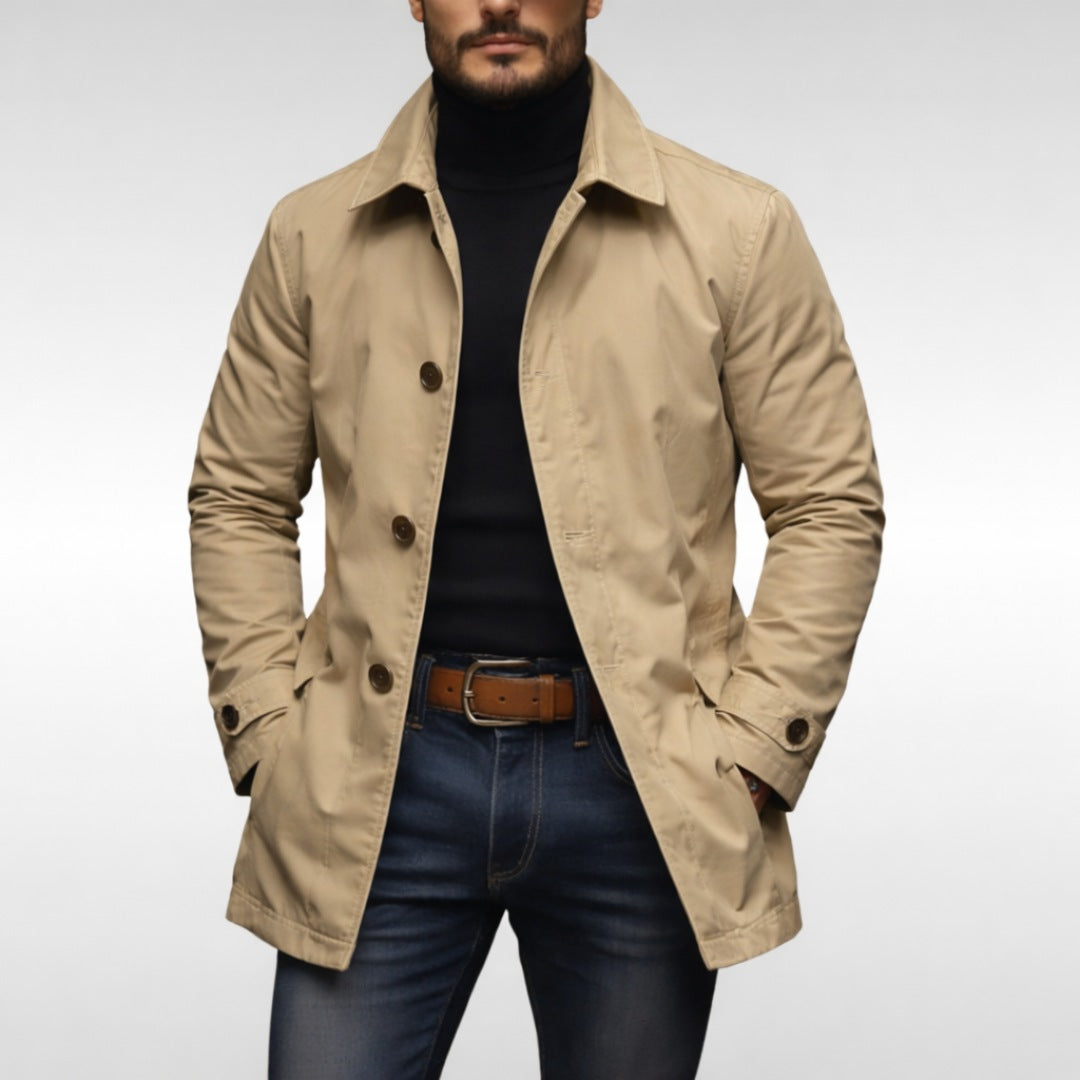 Man wearing beige button-front trench coat over black turtleneck and jeans | Chaps London