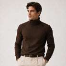 Man wearing brown fine knit roll neck jumper with ribbed collar and beige trousers | Chaps London