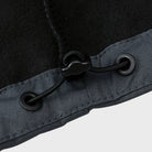 Close-up of black cord lock and grommets on gray jacket hem | Chaps London