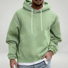 Man wearing sage green hooded sweatshirt with white drawstrings and front pocket | Chaps London