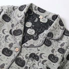 Grey pyjama collar close-up with pumpkin and moon print, lying flat | Chaps London