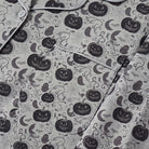 Grey pyjama fabric flat-laid with pumpkin, ghost, bat, and cobweb print | Chaps London