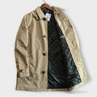 Beige cotton rain mac coat on hanger, quilted black lining visible | Chaps London
