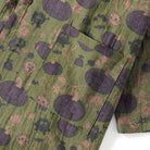 Green kimono fabric with purple pumpkins and monster print, close-up pocket detail | Chaps London