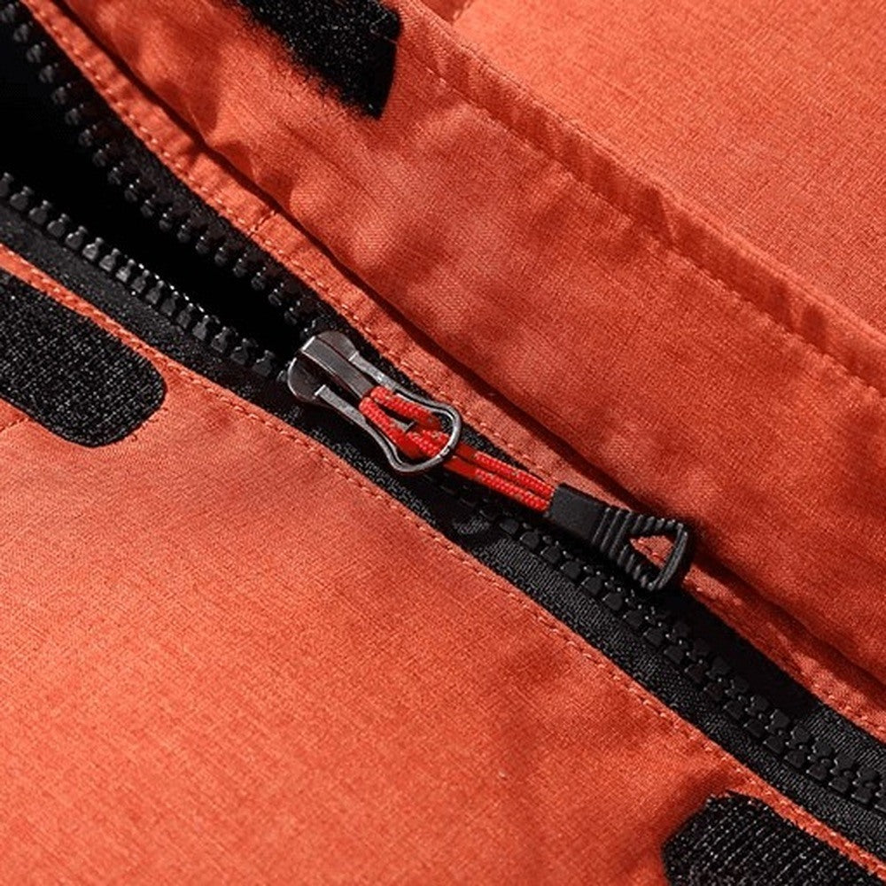 Close-up of orange jacket zipper pulls with black fabric trim detail | Chaps London