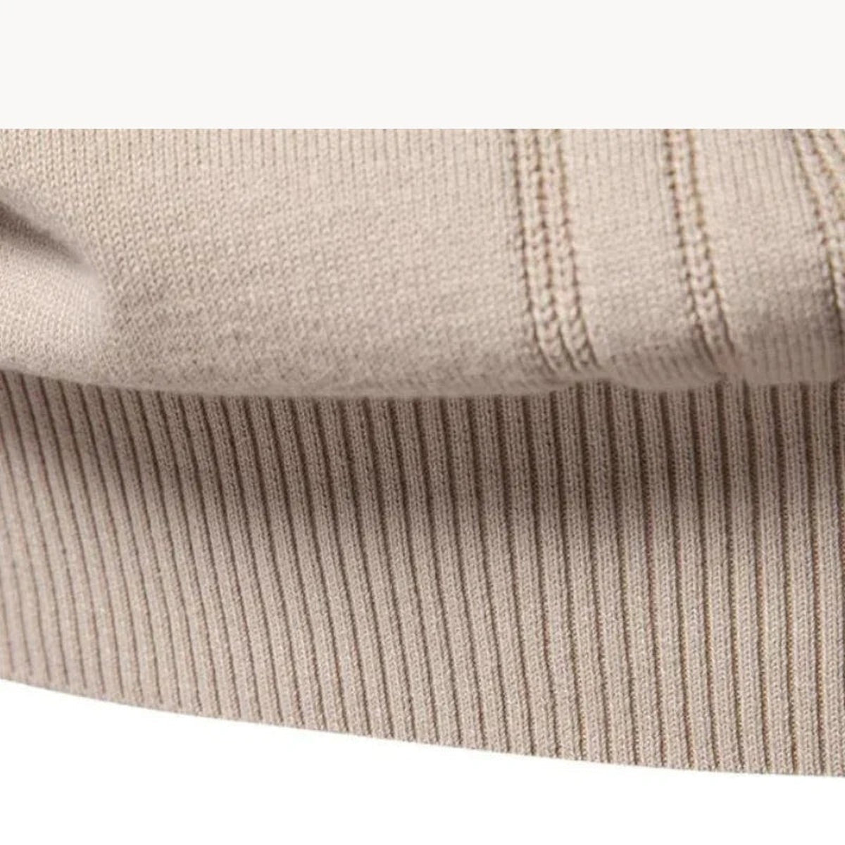 Close-up of beige ribbed knit fabric with contrast stitching detail, folded flat | Chaps London