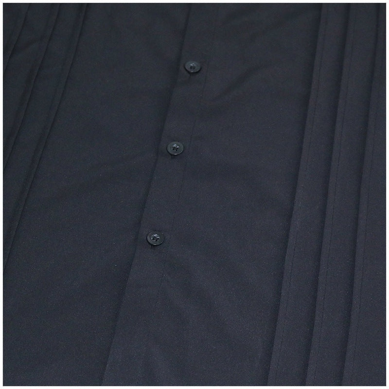 Close-up of black pleated shirt front with buttons, flat lay view | Chaps London