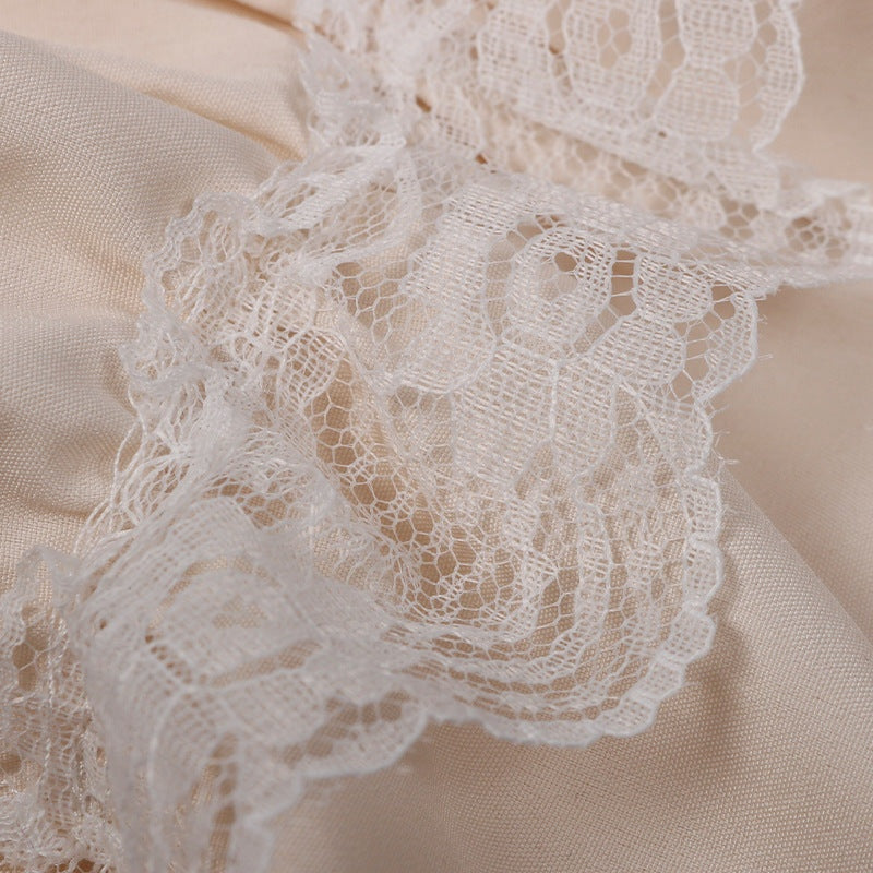 Close-up of cream ruffled lace trim on fabric | Chaps London