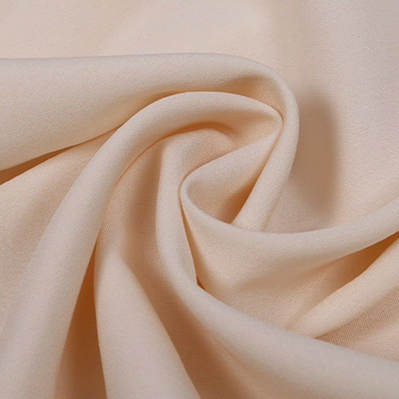 Swirled peach-colored fabric shown in close-up, flat textile texture | Chaps London