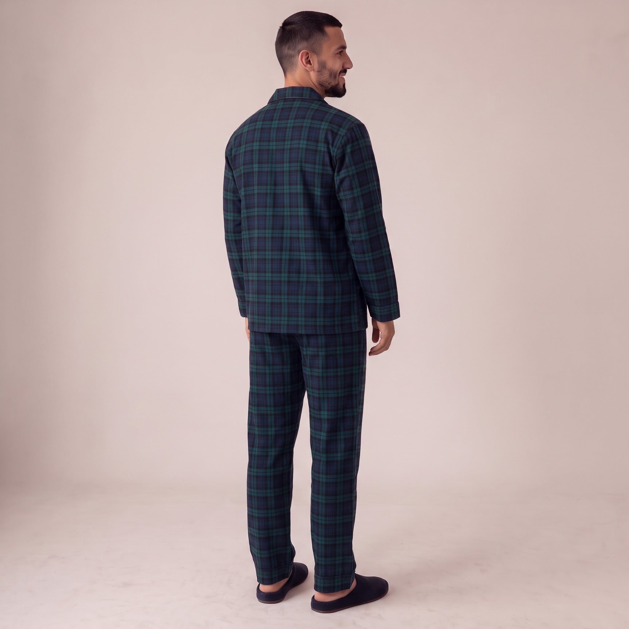 Man wearing green tartan flannel pyjama set, viewed from behind, standing | Chaps London