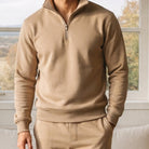 Man wearing beige half zip sweatshirt with matching joggers indoors | Chaps London