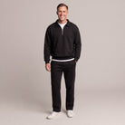 Man wearing black quarter-zip sweatshirt and matching black joggers with sneakers | Chaps London