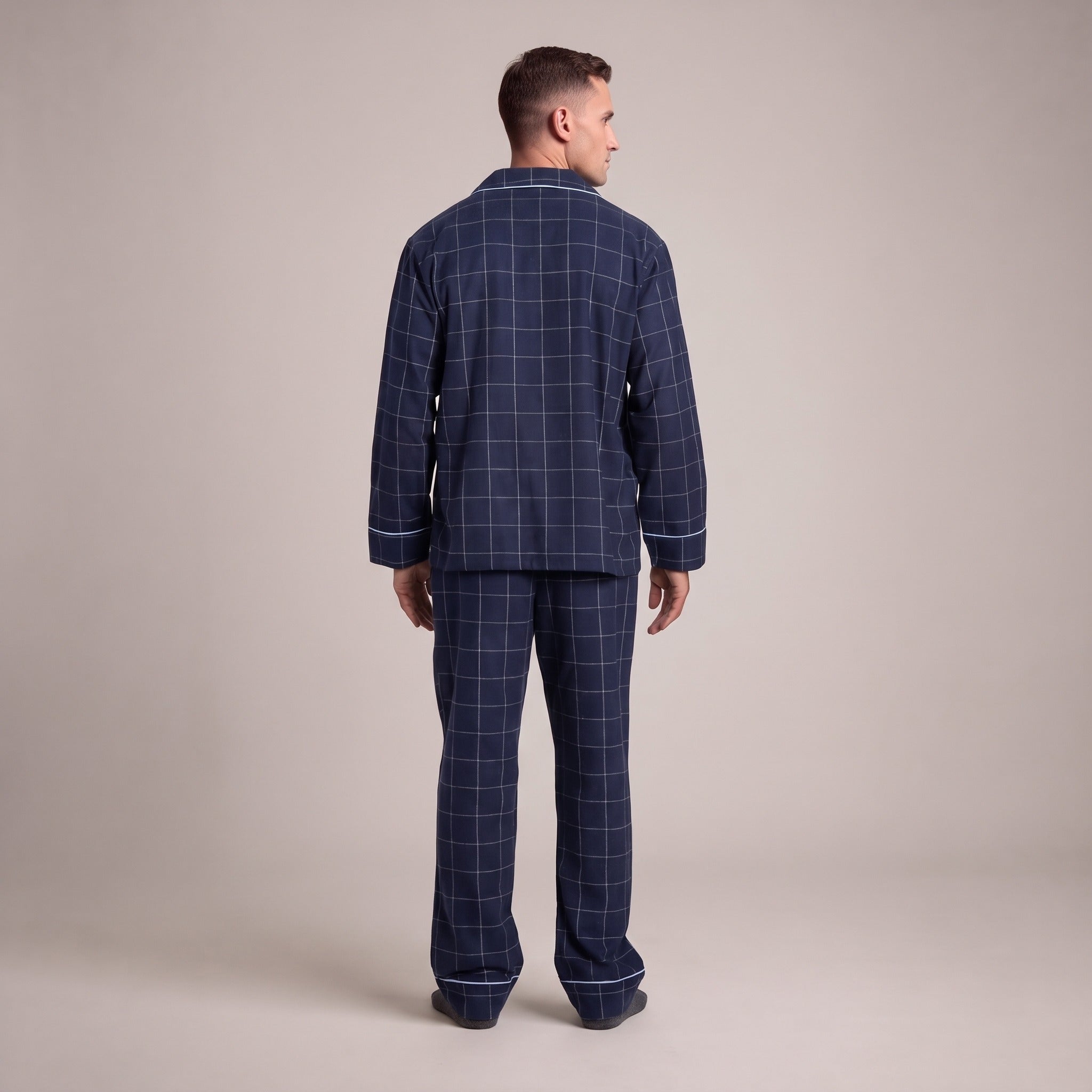Man wearing navy windowpane check flannel pyjama set, rear view standing | Chaps London