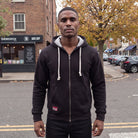 Man wearing the black zip-up hoodie on a London street | Chaps London