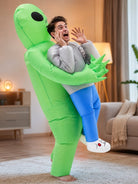 Man wearing green inflatable alien costume carrying fake human legs | Chaps London