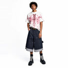 White oversized T-shirt with pink skeleton print, worn by male model | Chaps London