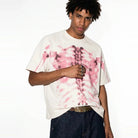 Man wearing cream oversized t-shirt with pink skeleton ribcage print design | Chaps London