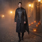 Man wearing black jacquard gothic hooded coat with shoulder cape, nighttime street | Chaps London