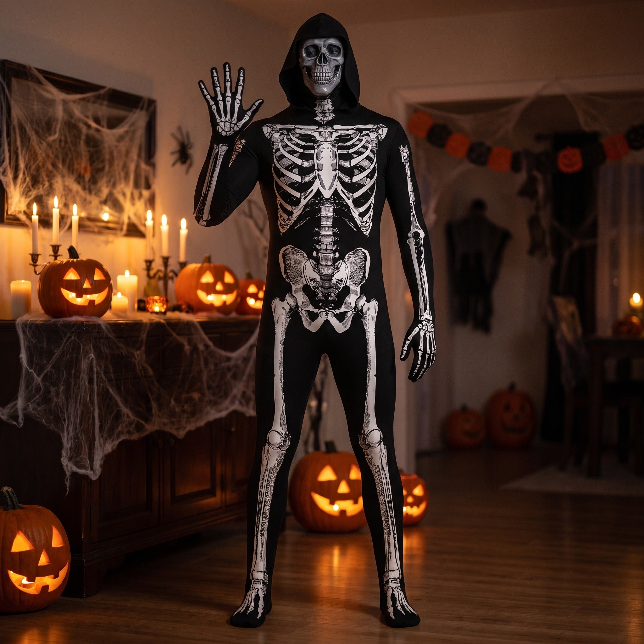 Person wearing black hooded skeleton onesie with bone print, Halloween decor background | Chaps London