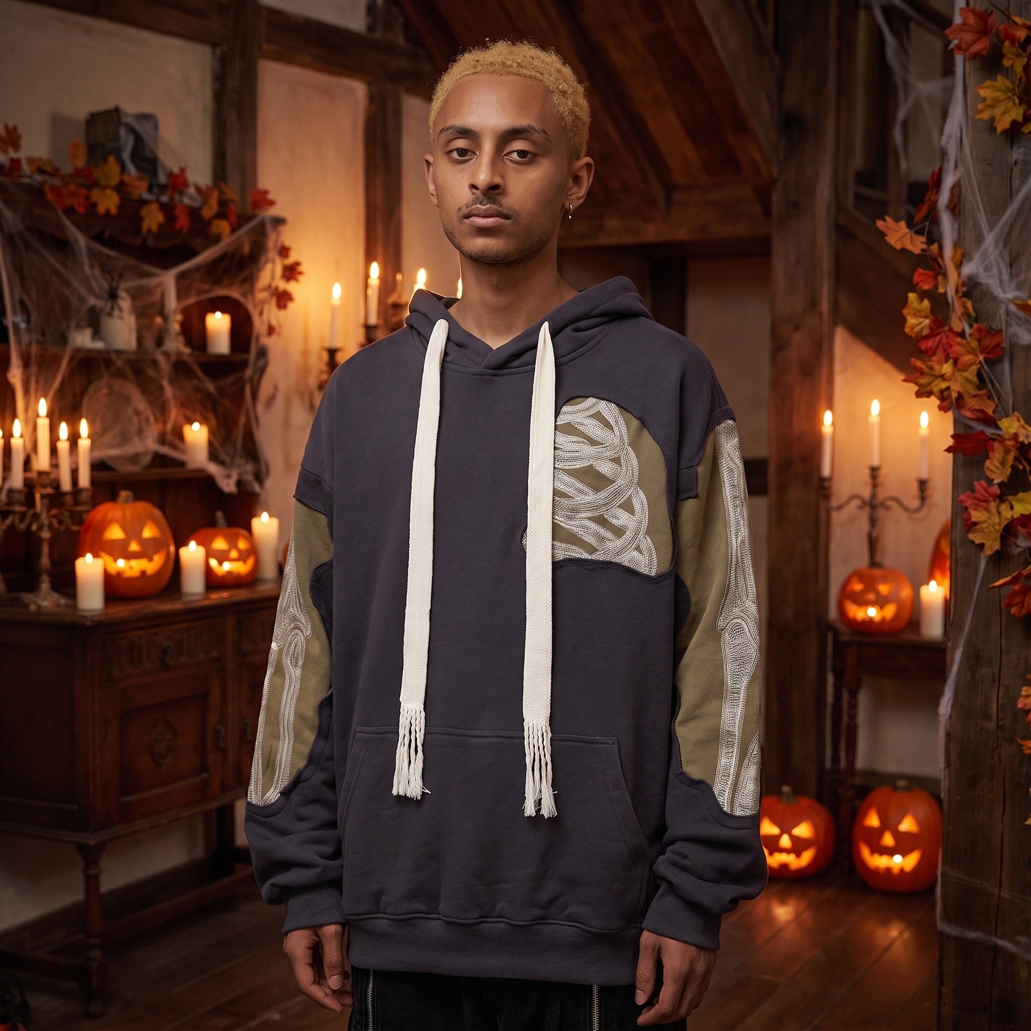 Man wearing dark grey patchwork hoodie with embroidered bone sleeve details | Chaps London