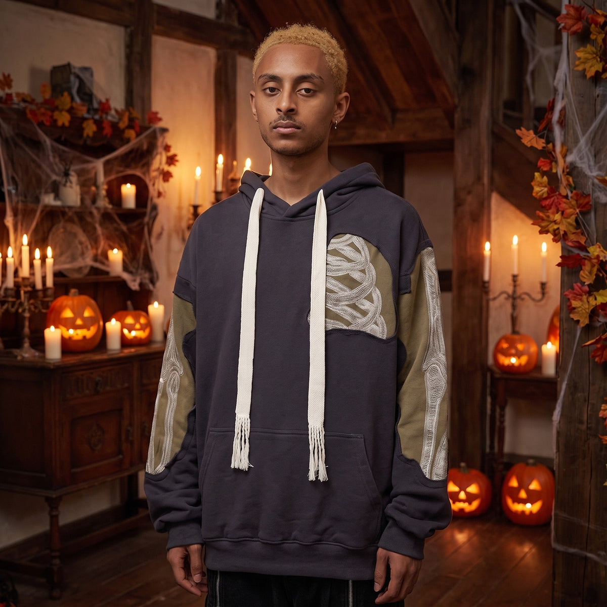 Man wearing dark grey patchwork hoodie with embroidered bone sleeve details | Chaps London