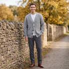 Man wearing grey ribbed knit cardigan with grey trousers on stone pathway | Chaps London