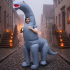 Man wearing gray inflatable long-neck dinosaur costume on foggy cobblestone street | Chaps London